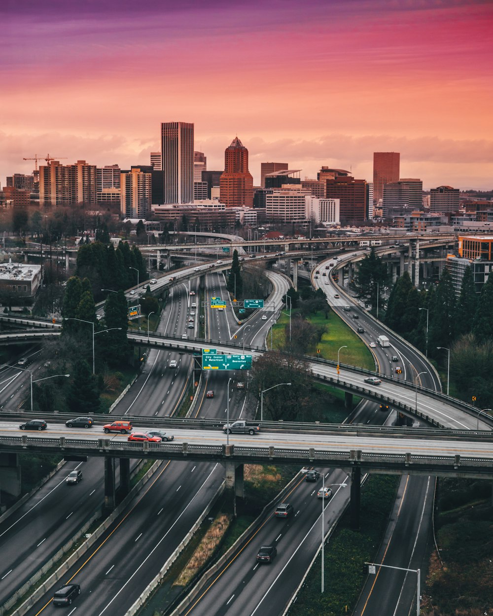 a city skyline with a freeway and a bridge