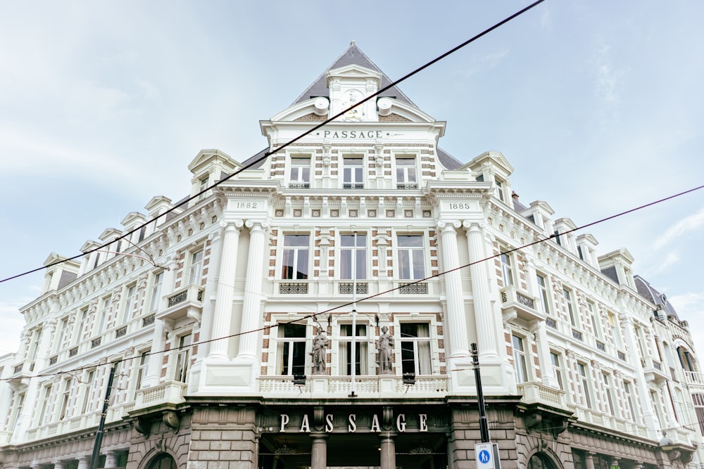 a large white building with a clock on the top of it