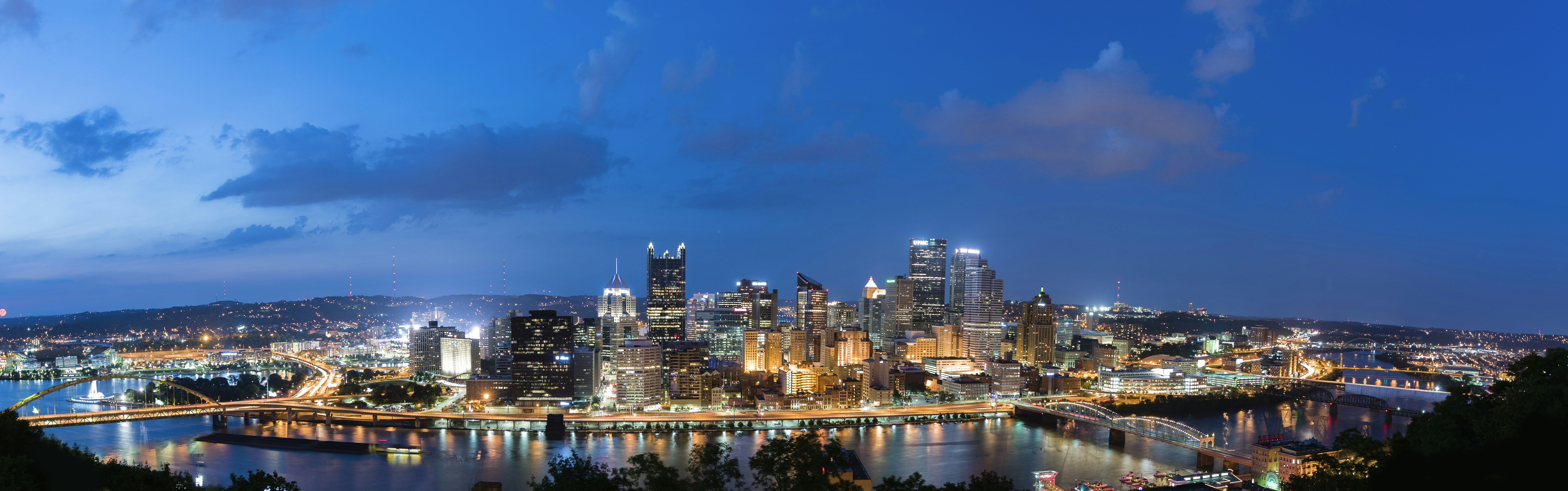 a view of a city at night from the top of a hill