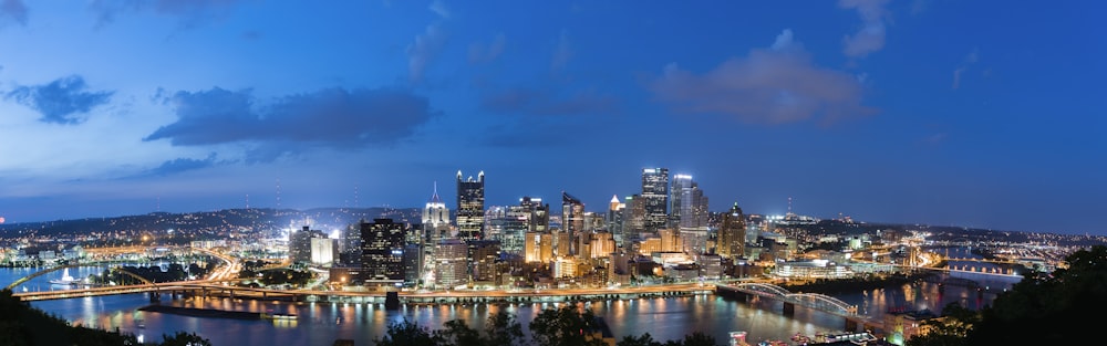 a view of a city at night from the top of a hill