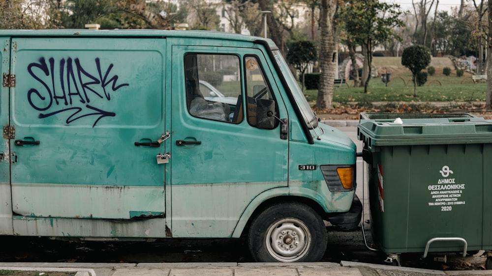 a blue van with graffiti on the side of it