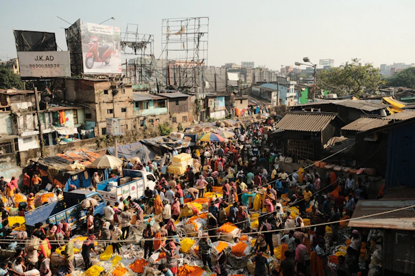 Vibrant market scene in Mogadishu with colorful stalls and lively crowds near the ocean shore.