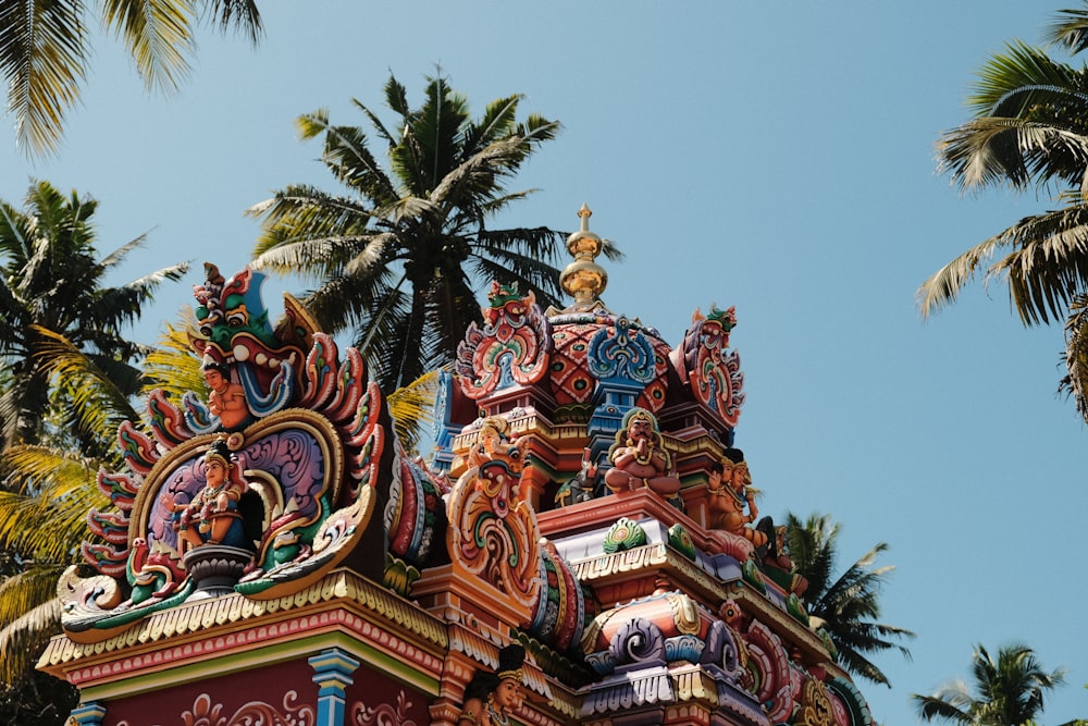 a colorful building with a palm tree in the background