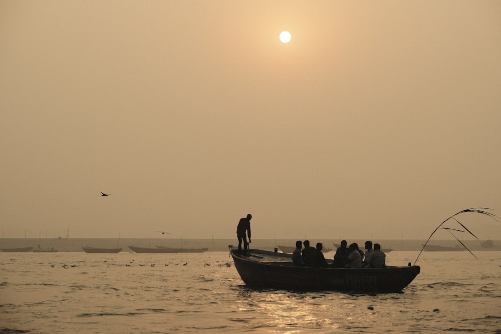 a group of people on a boat in the water