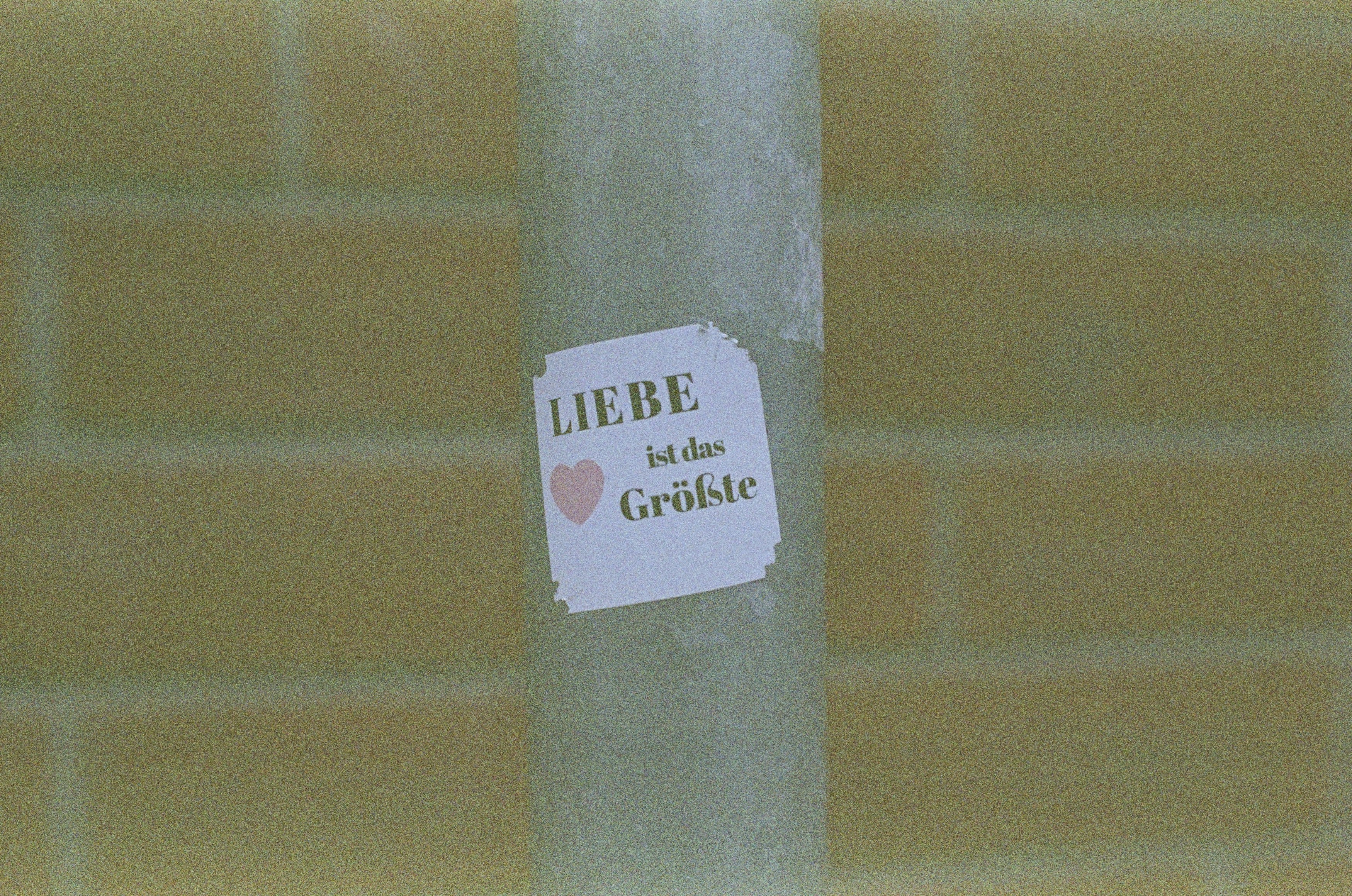 a sticker on a pole with a message on it