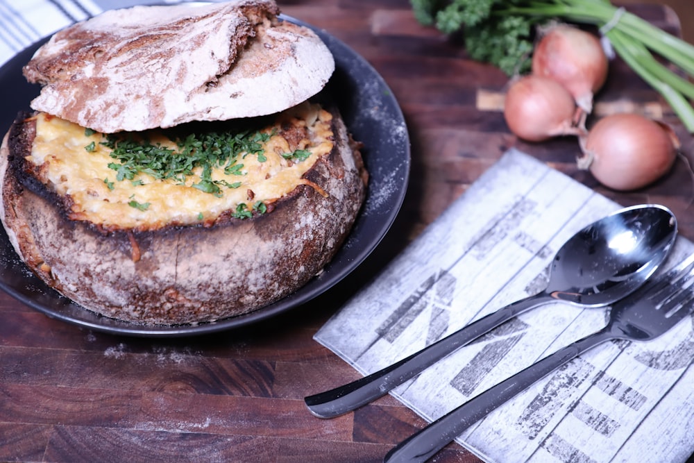 a black plate with a sandwich on top of it