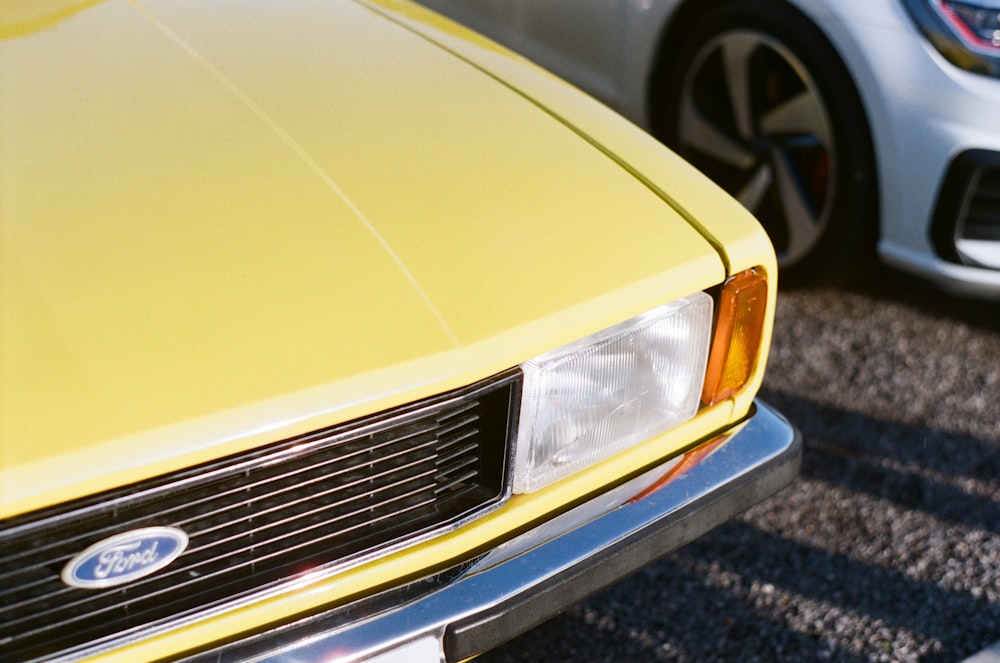 a close up of a yellow ford mustang