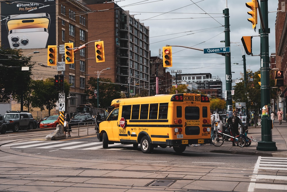 a yellow school bus driving down a street