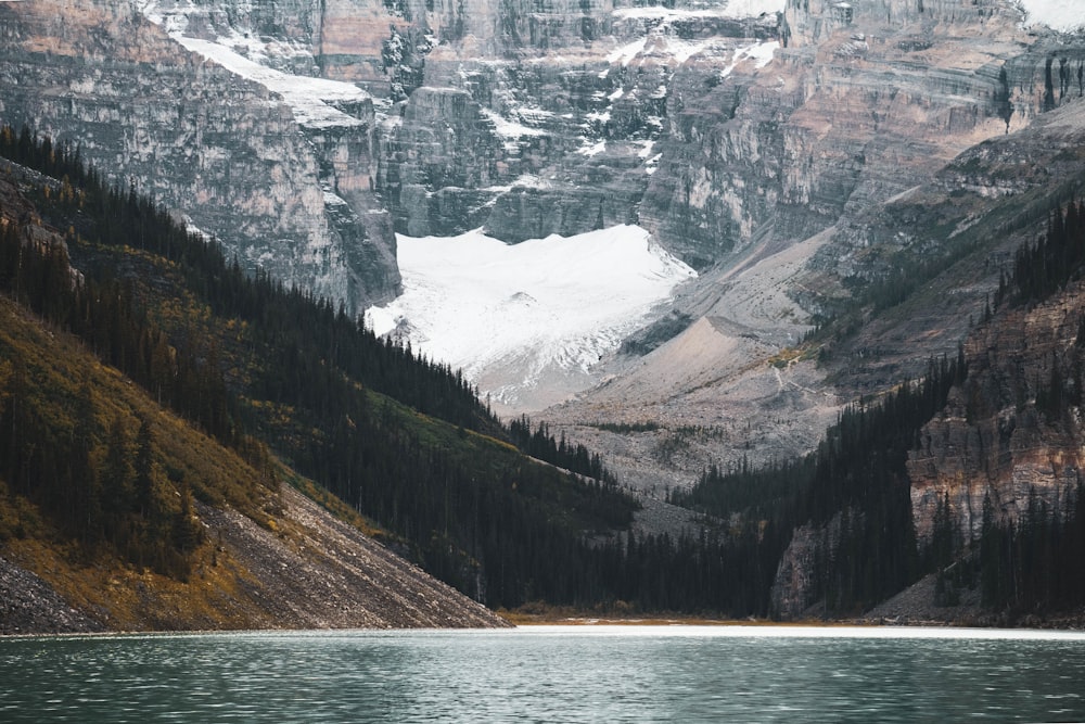 a mountain range with a lake in the foreground