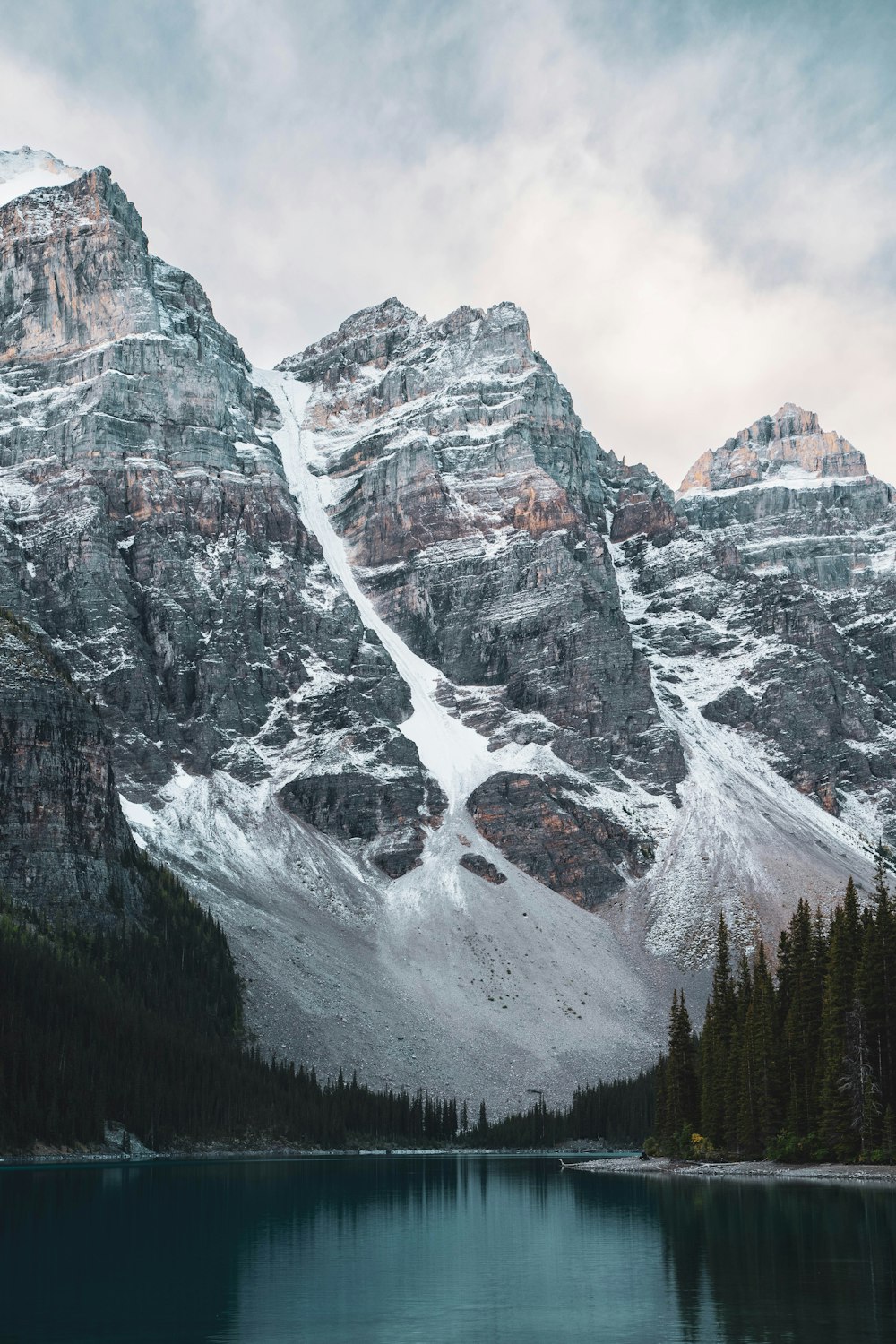 a mountain range with a lake in the foreground