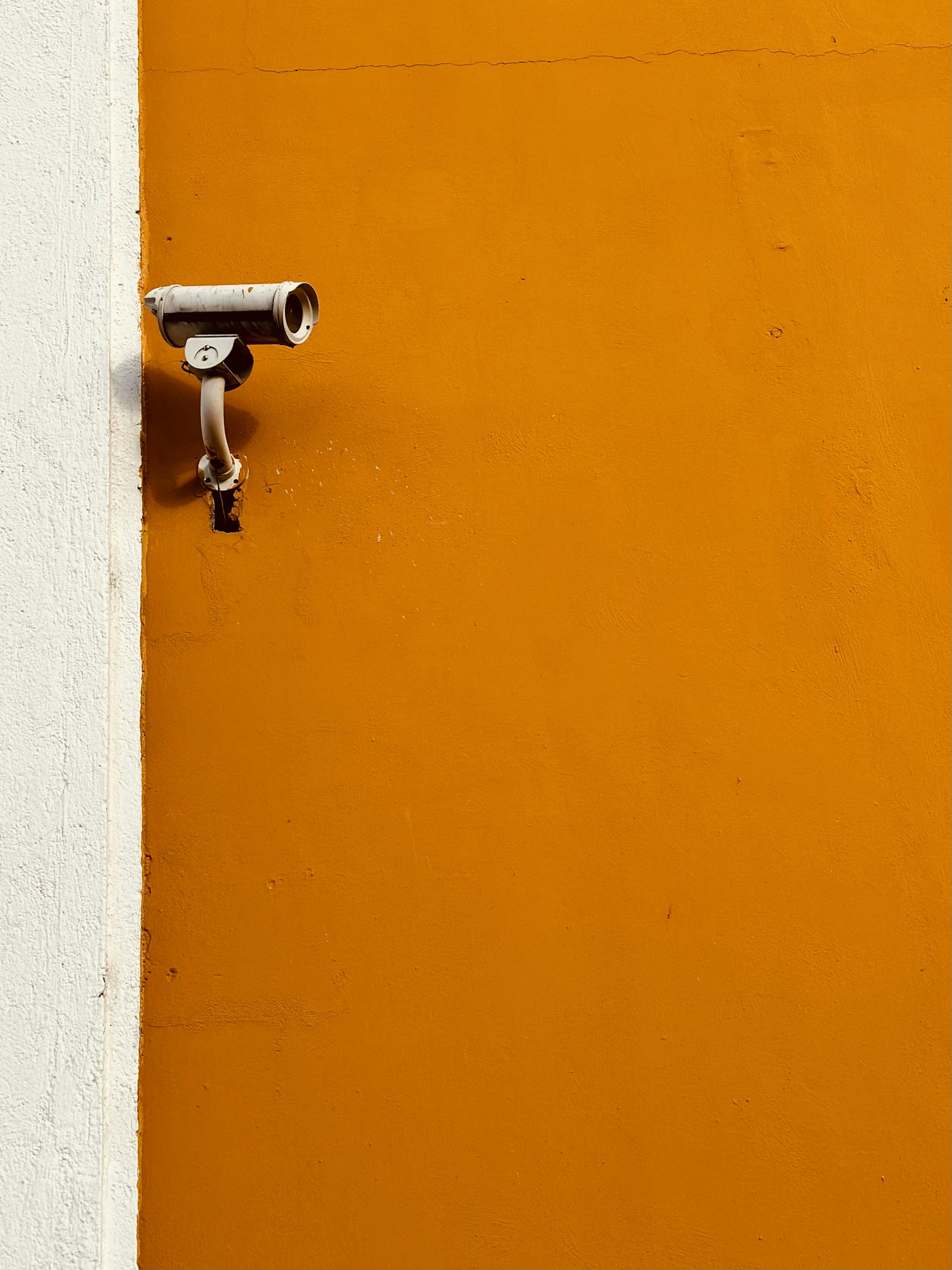 a security camera mounted to the side of a building