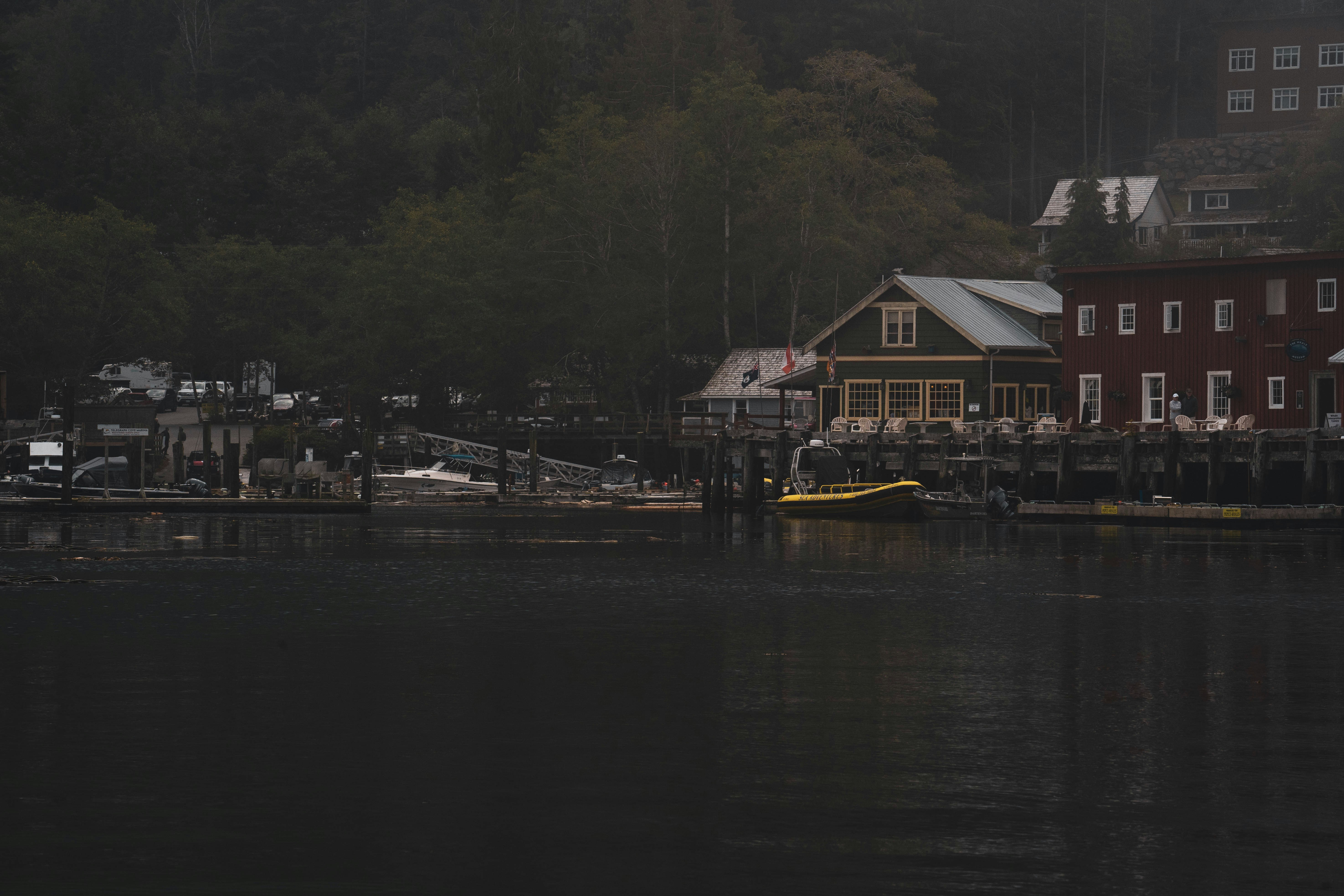 a body of water next to a red building