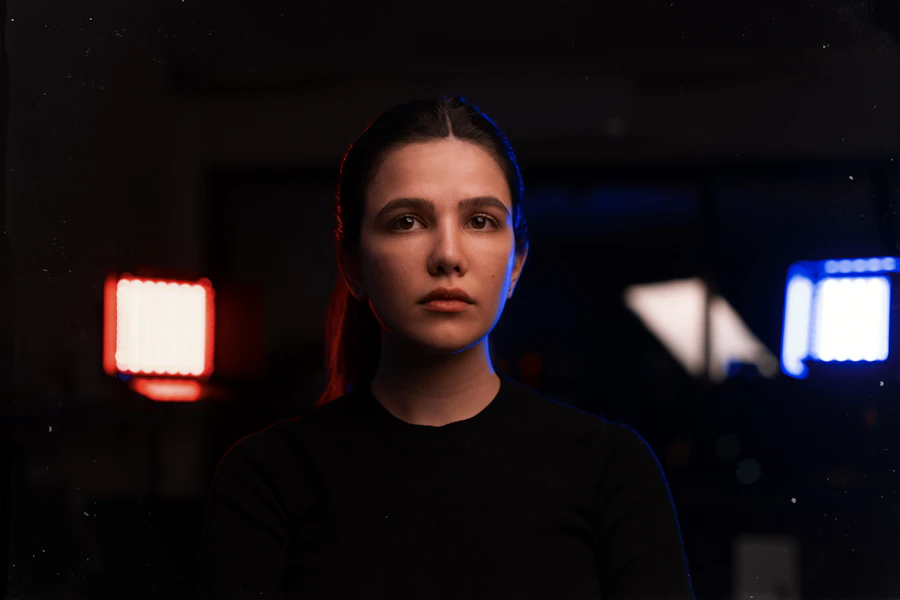A woman in a dark room lit by a single red lamp