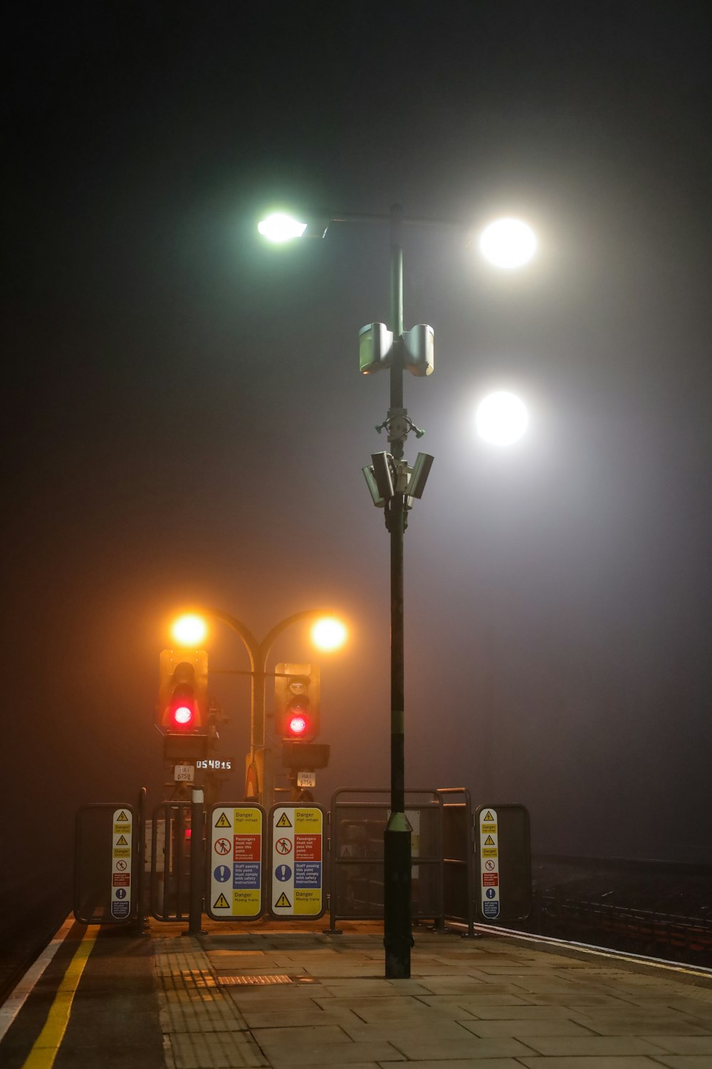a couple of street lights on a foggy night