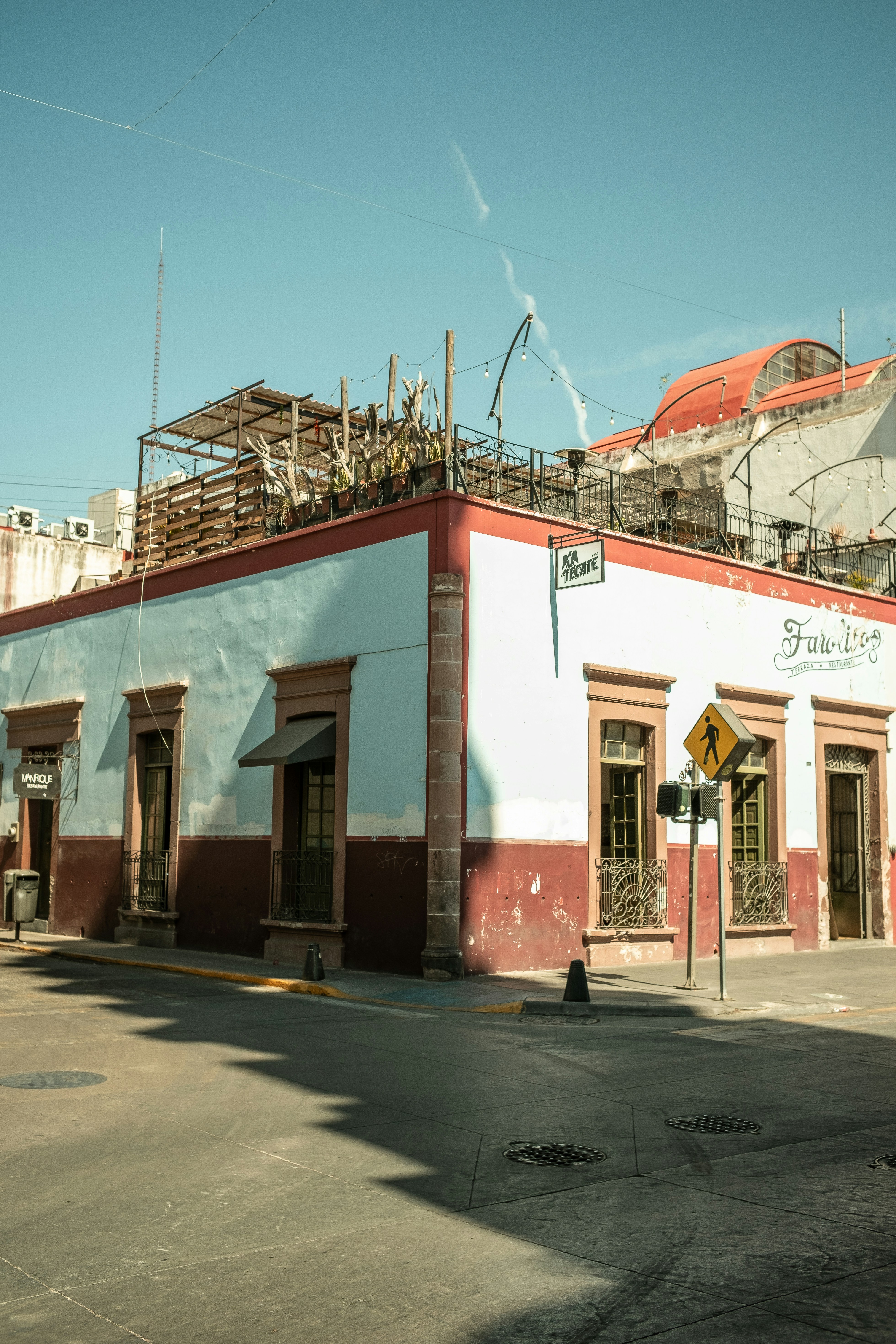 a red and white building sitting on the side of a road