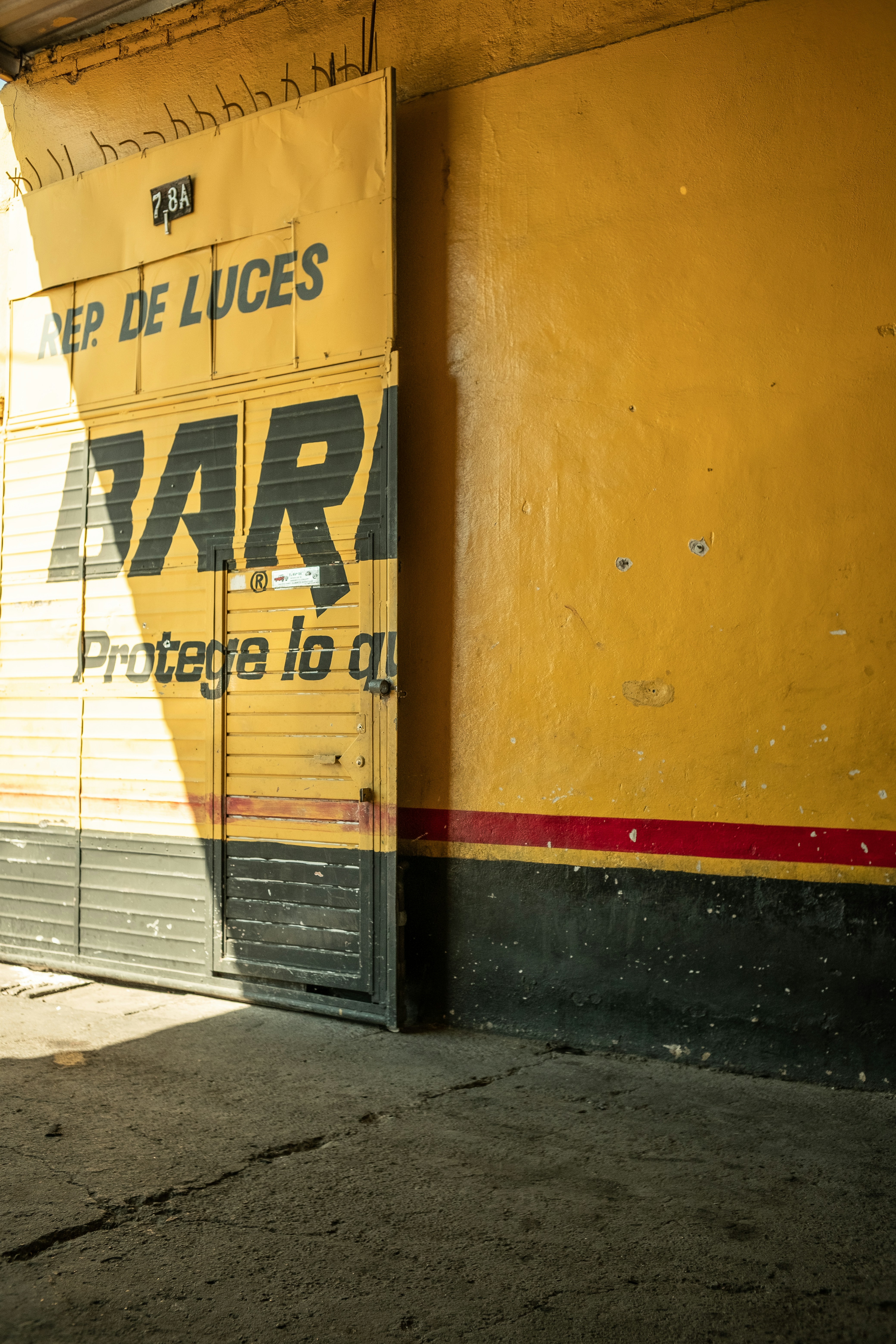 a yellow building with a sign on the side of it
