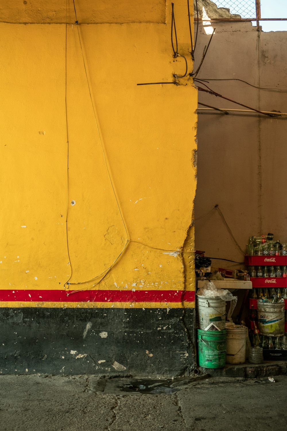 a yellow building with a red stripe on the side of it