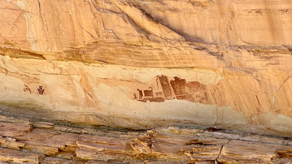 a rock wall with a painting on it