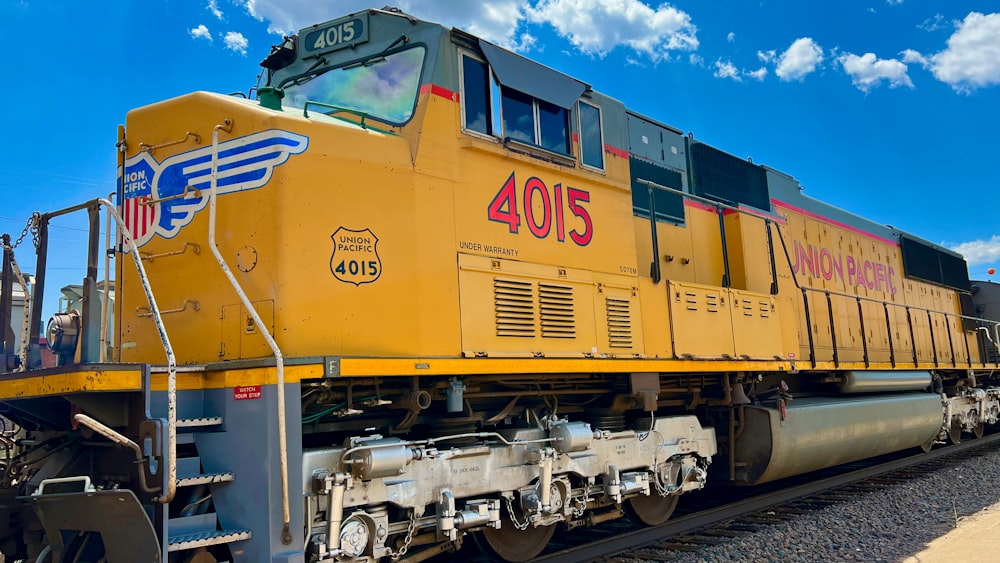 a large yellow train on a steel track