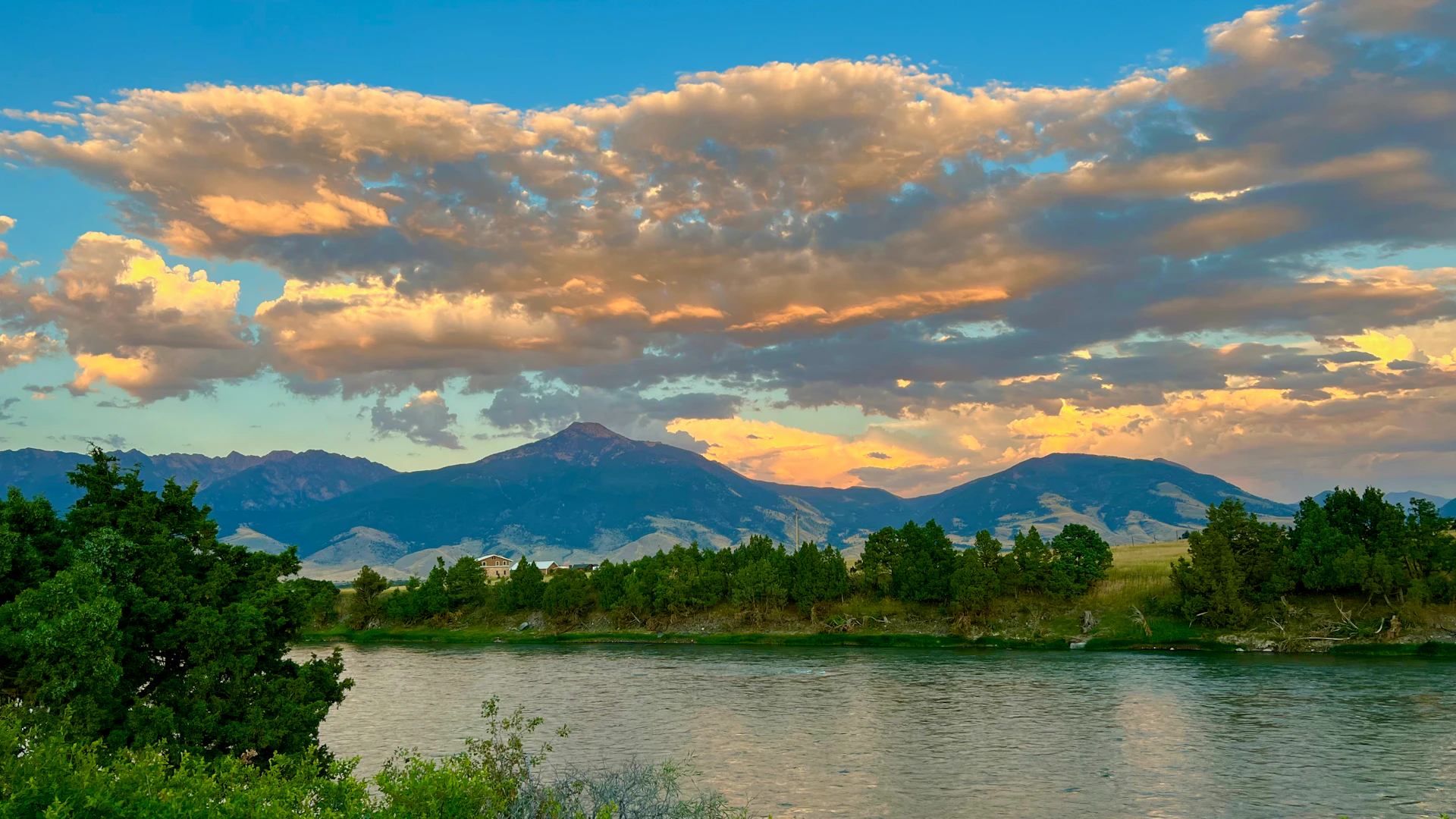 a river with a mountain range in the background