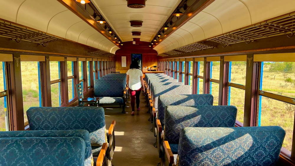 a person standing in the middle of a train car