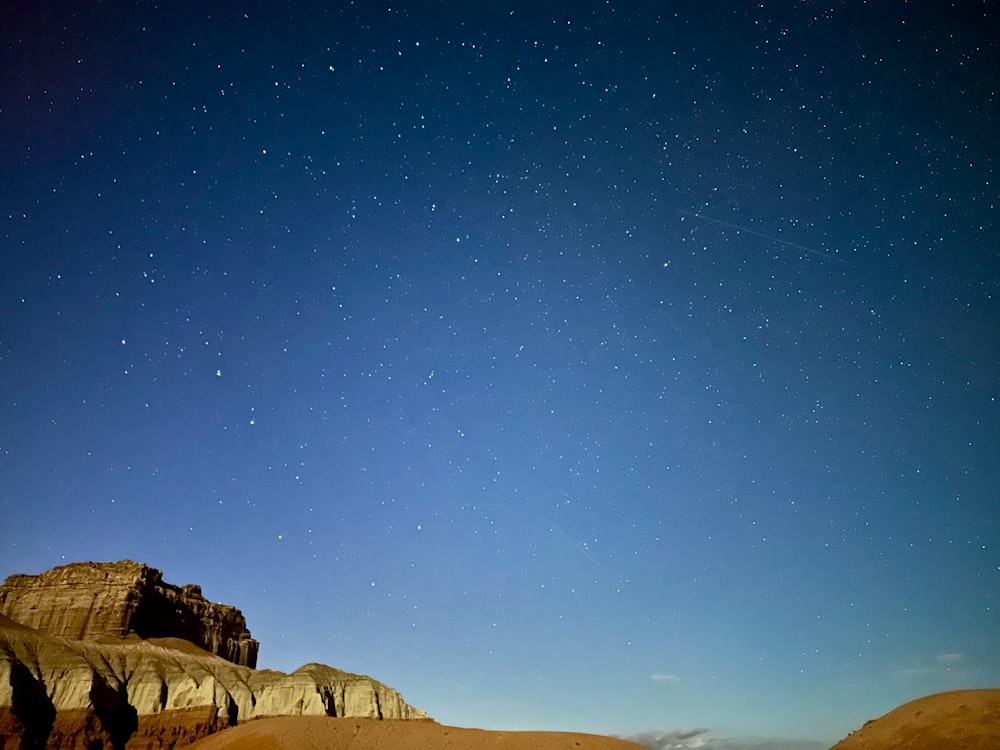 the night sky over the desert with stars