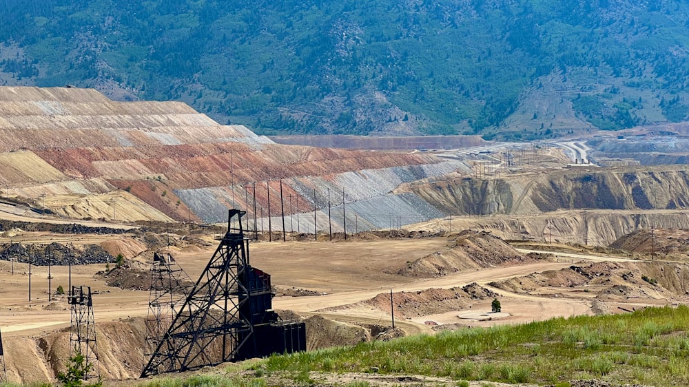 a view of a large open pit with a mountain in the background