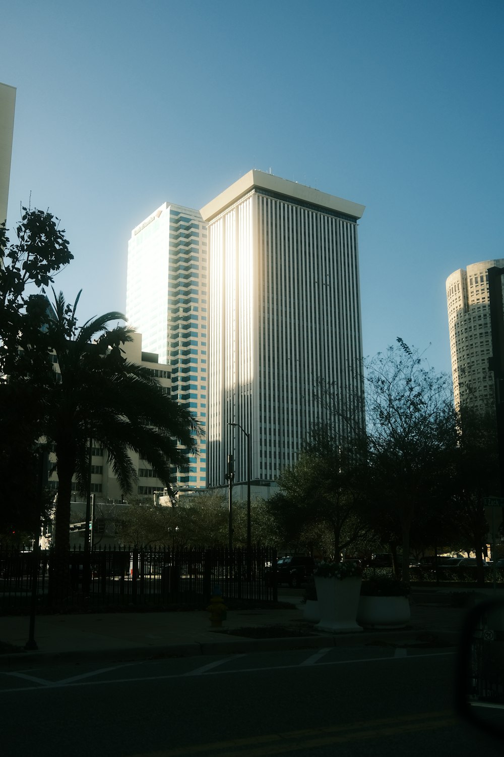 a city street with tall buildings in the background