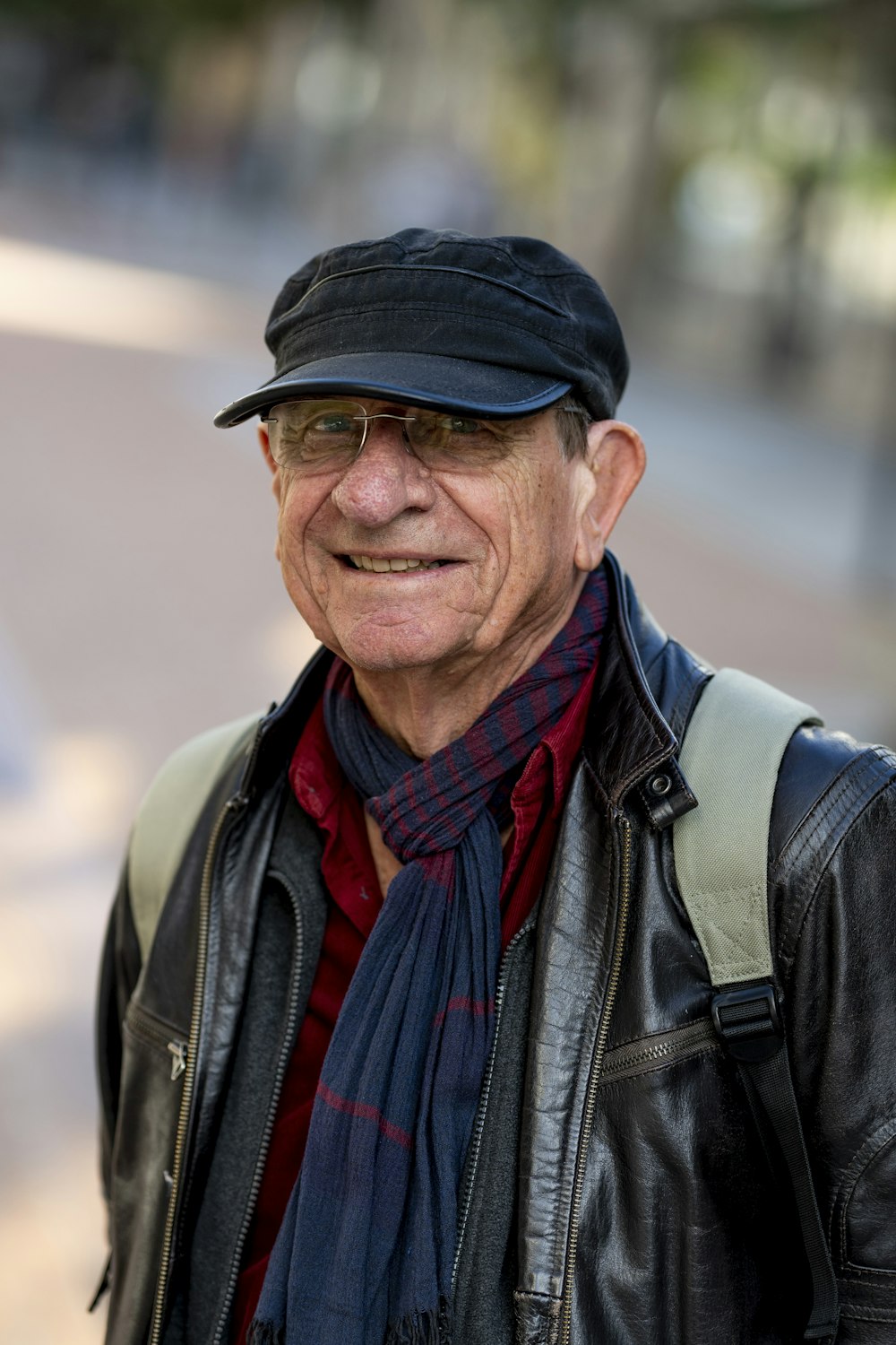 an old man wearing a hat and a scarf