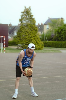 A basketball player practicing dribbling on the court.