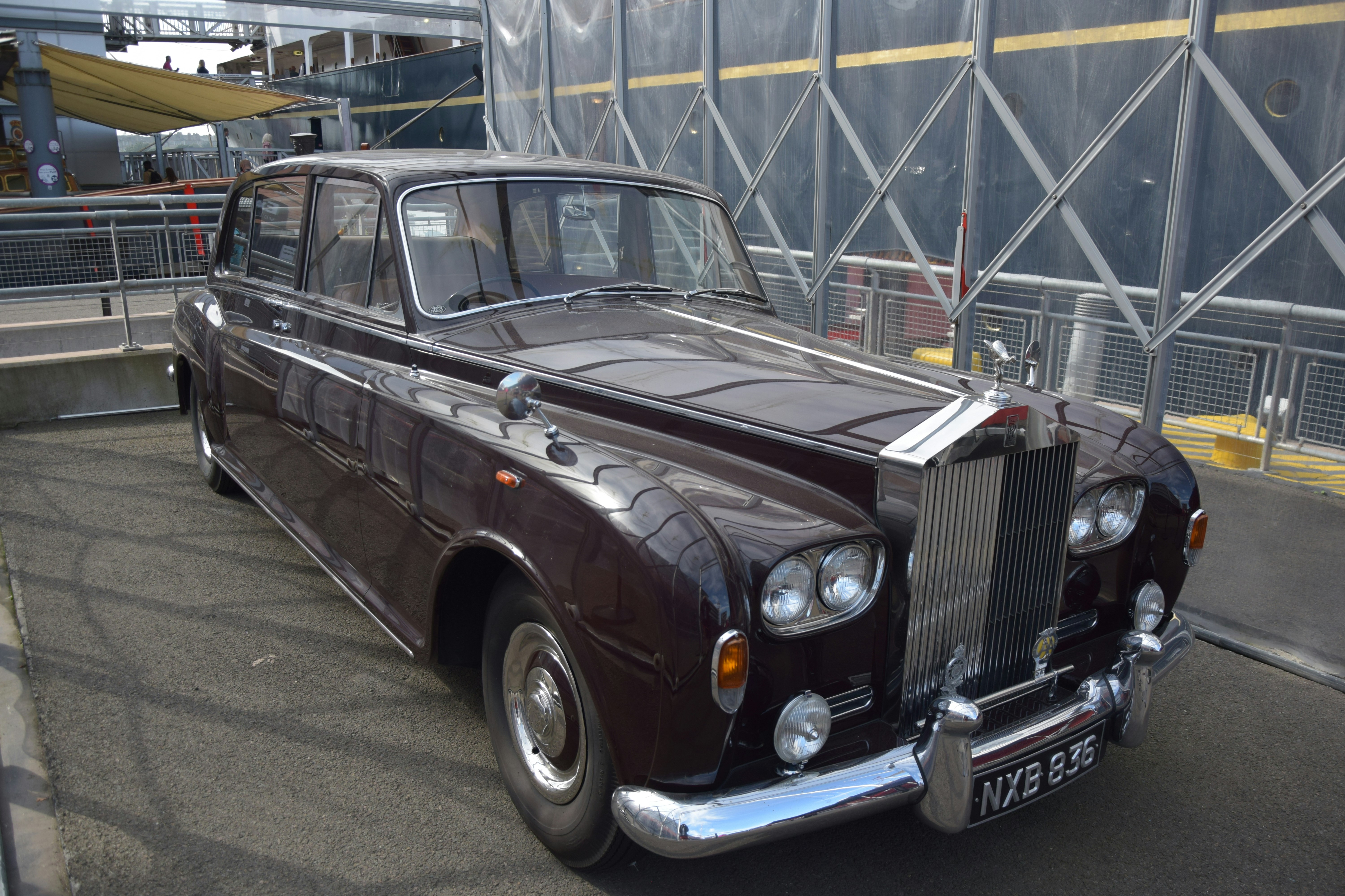 an old fashioned car parked in a parking lot