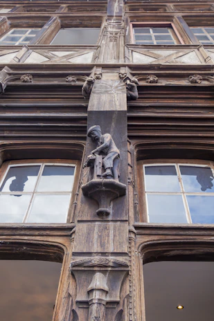 Close-up of artisans restoring delicate wooden carvings on a 18th-century Brazilian heritage building.
