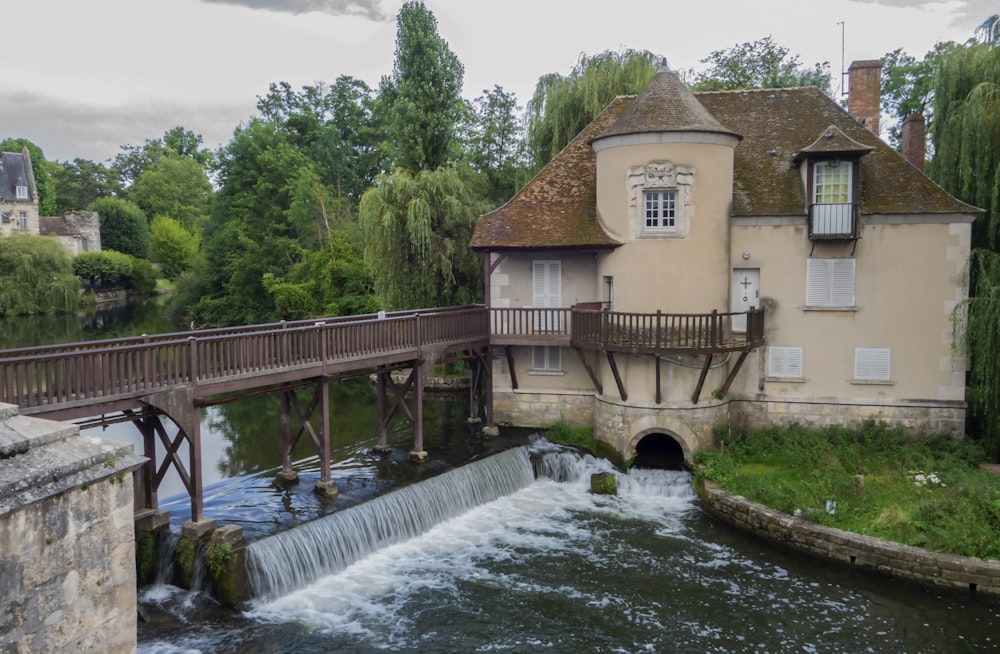 a river running under a bridge next to a building