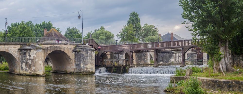 a bridge over a river with a waterfall