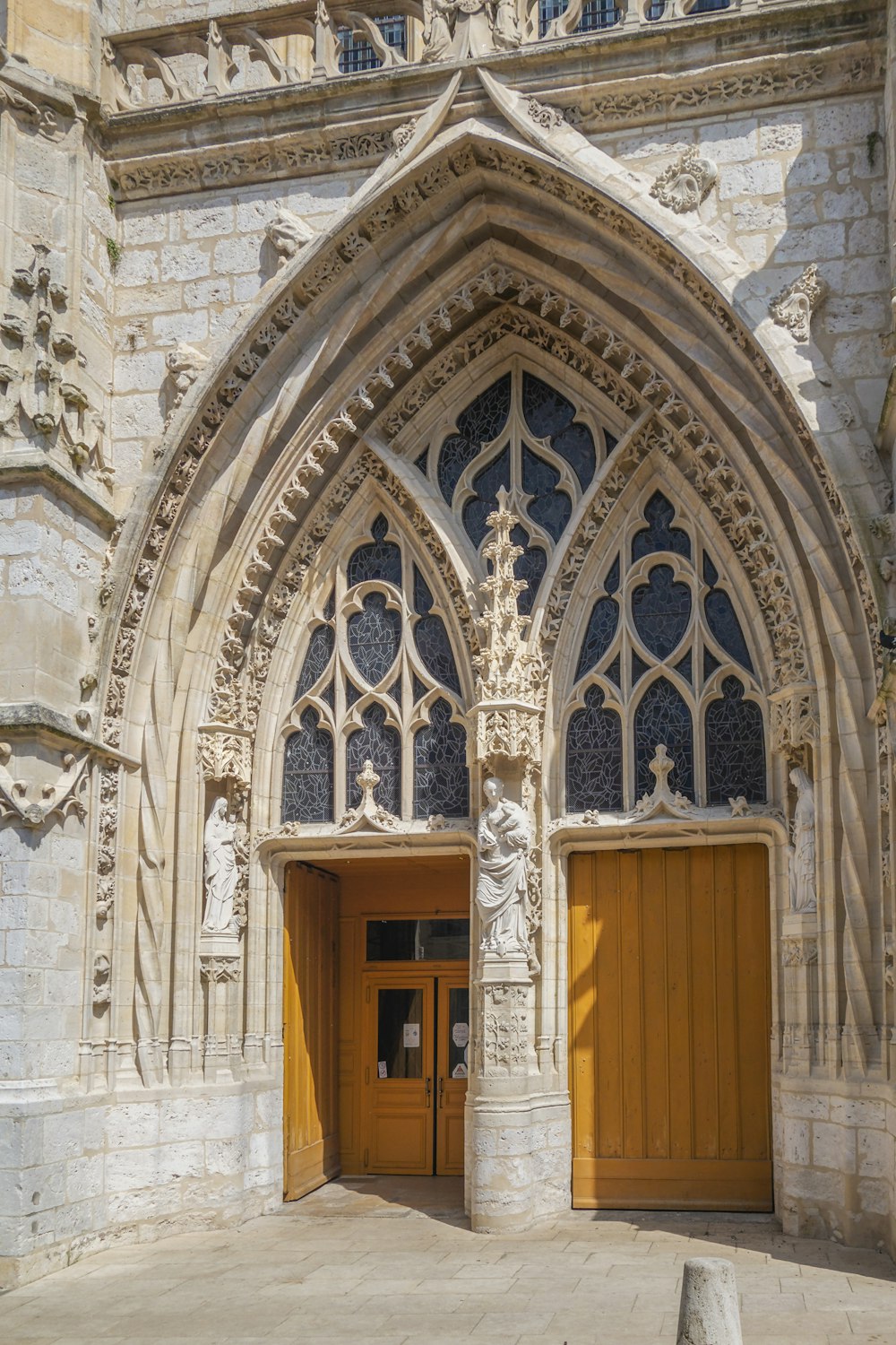 a large stone building with two wooden doors