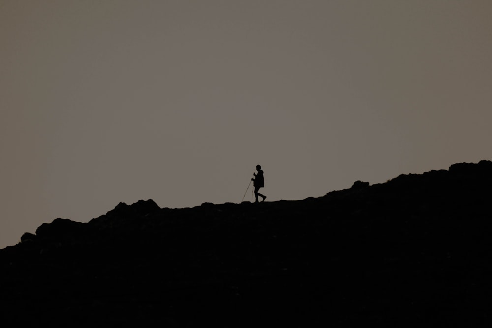 a person standing on top of a rocky hill