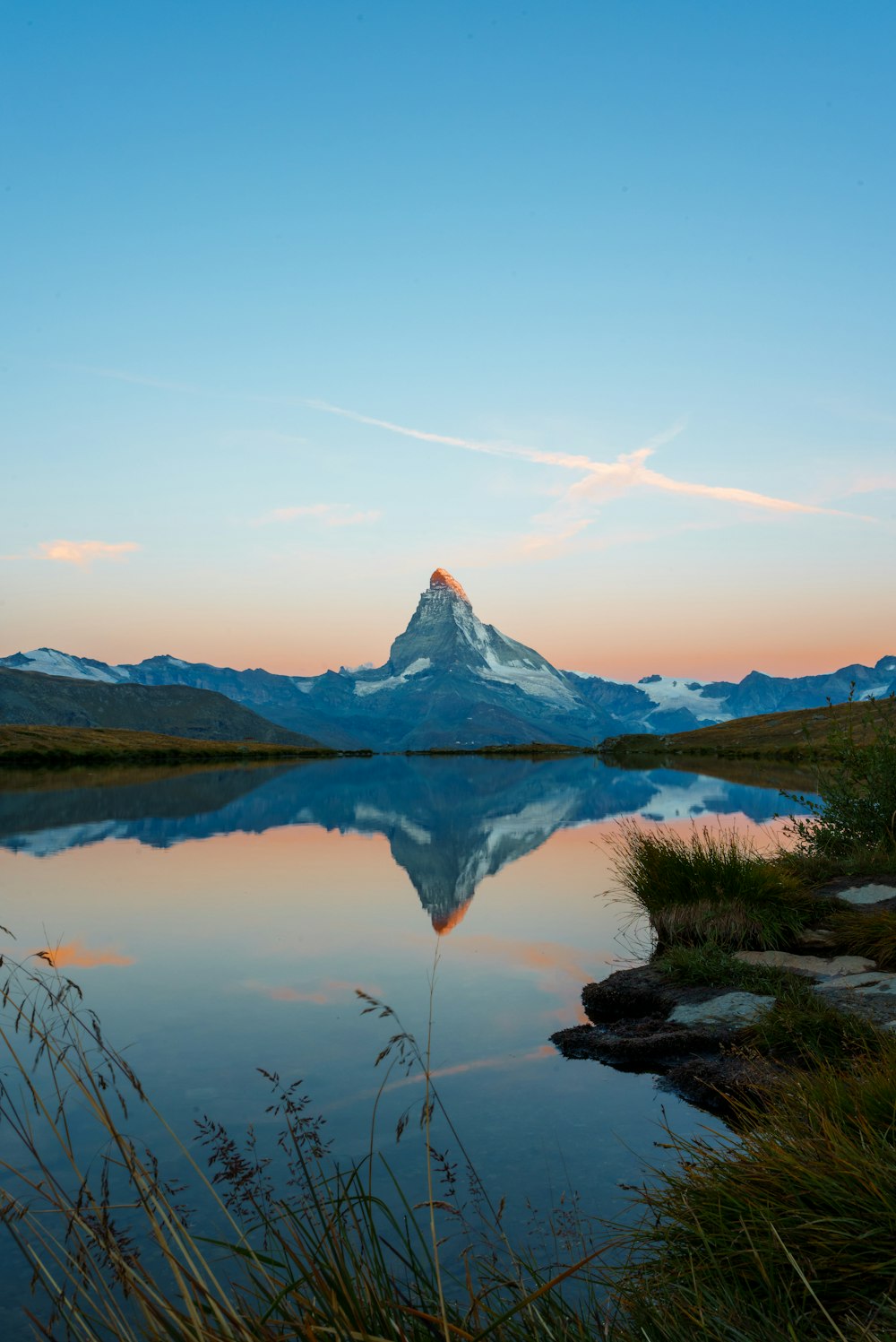 a mountain is reflected in the still water of a lake