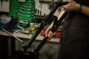 a man holding a bike in a garage