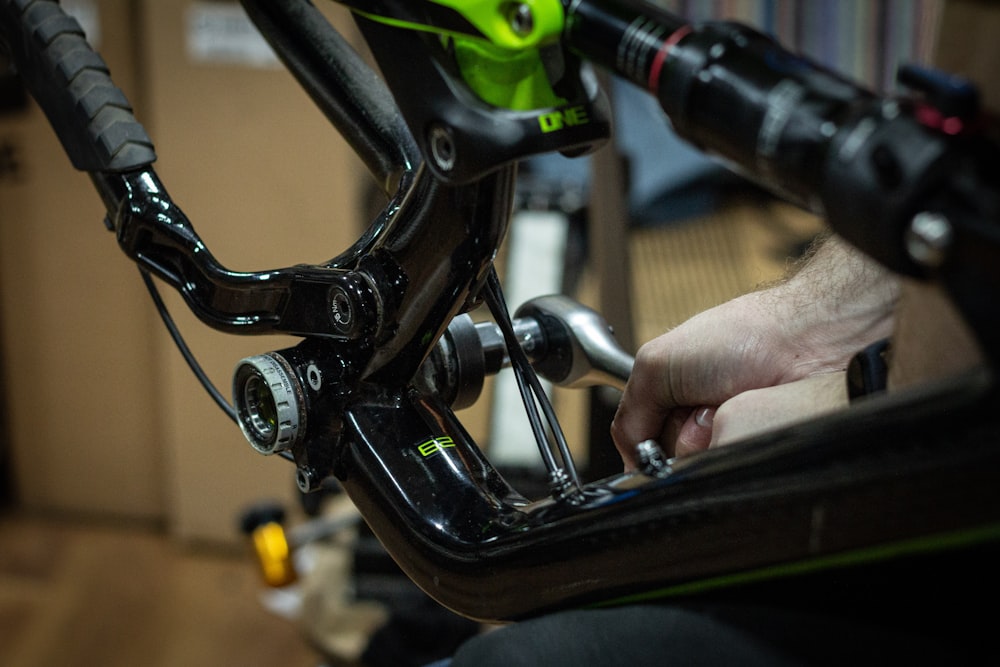 a close up of a person working on a bike