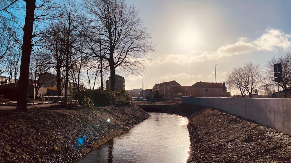 the sun is shining over a small river