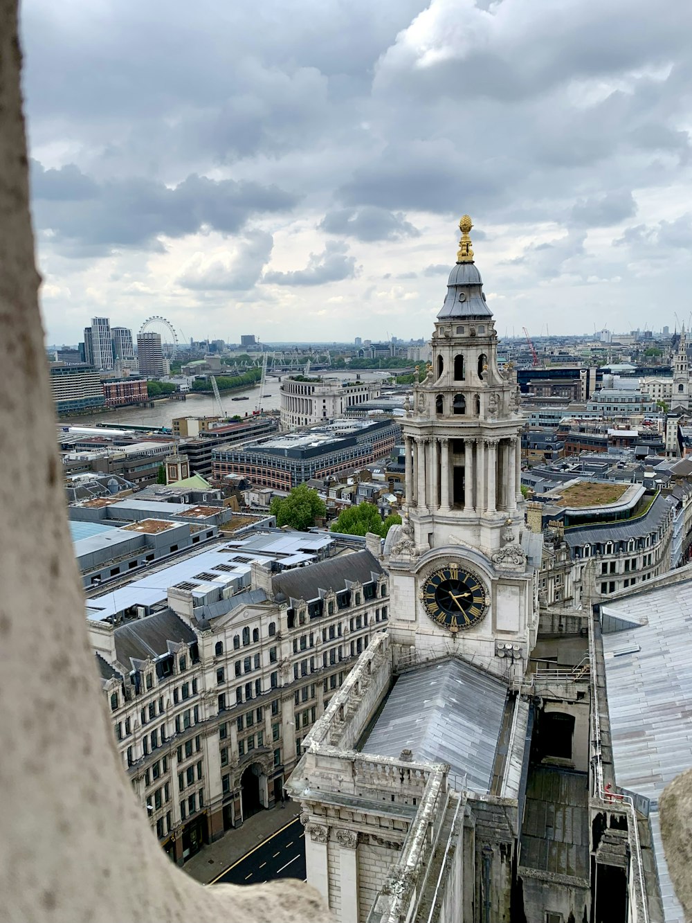 a view of a clock tower from the top of a building