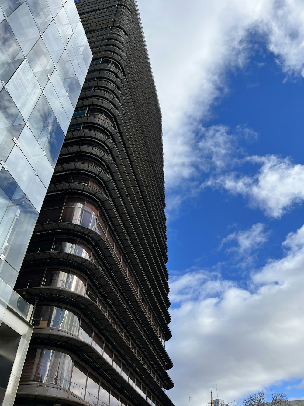 a tall building next to a tall glass building