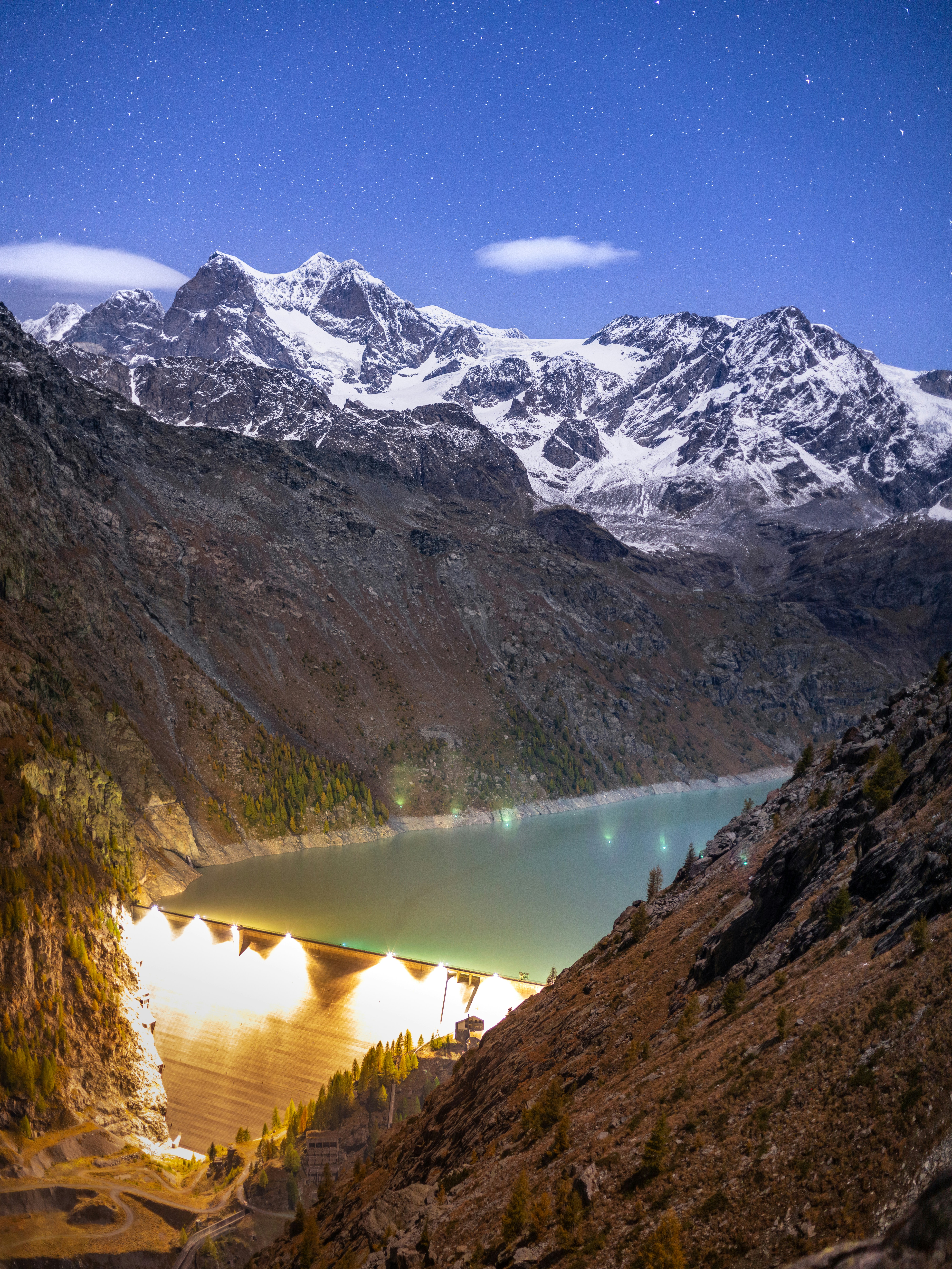 a view of a mountain range with a lake in the foreground