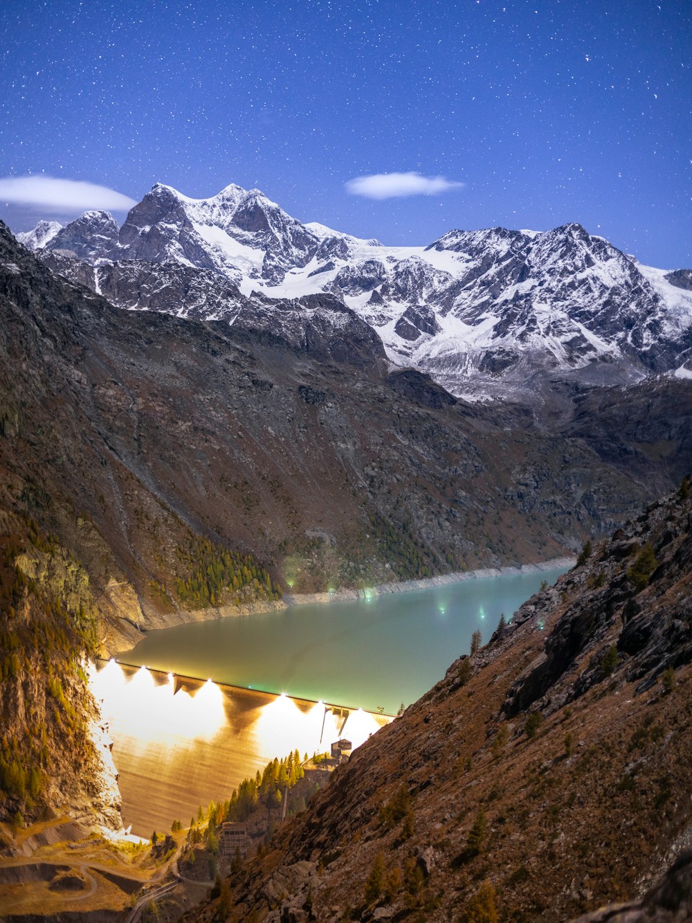 a view of a mountain range with a lake in the foreground