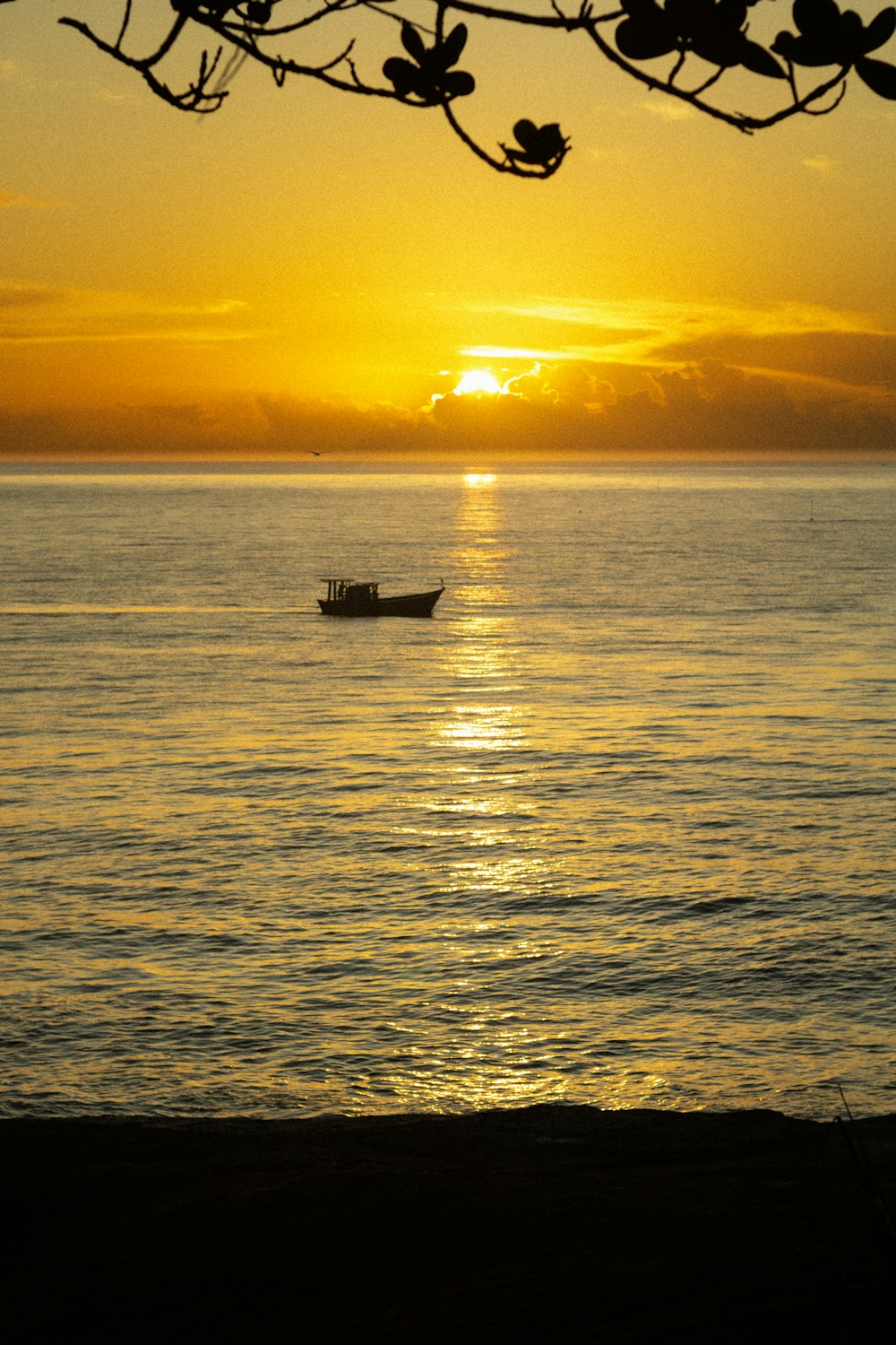 a small boat floating on top of a large body of water