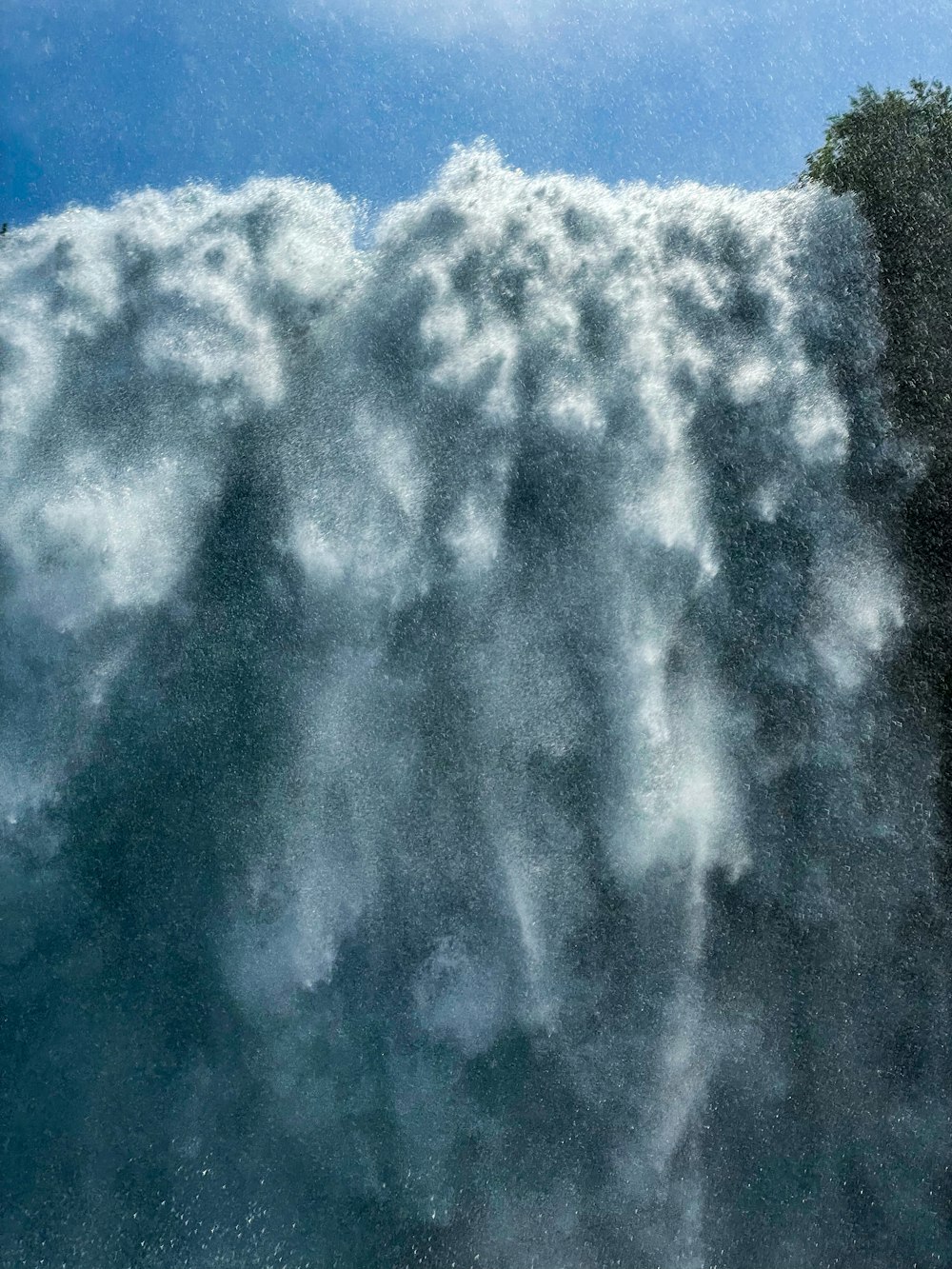 a man riding a surfboard on top of a wave