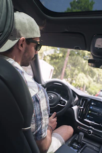Driver happily using the Zupcar app inside a clean, modern car in Santa Rosa de Viterbo.