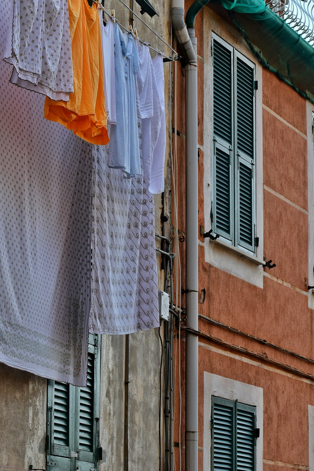 clothes hanging on a clothes line outside of a building