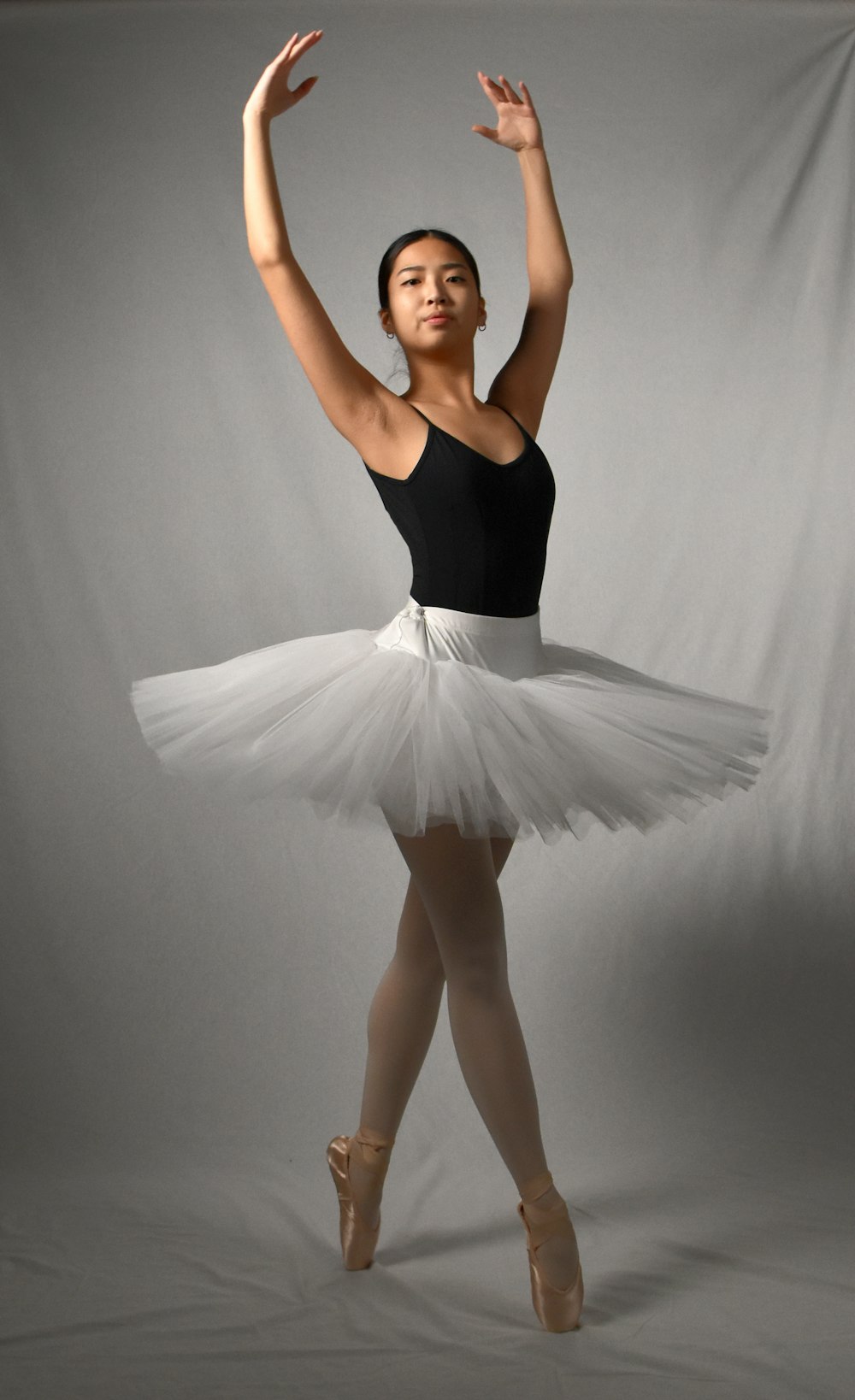 a woman in a black top and white tutu