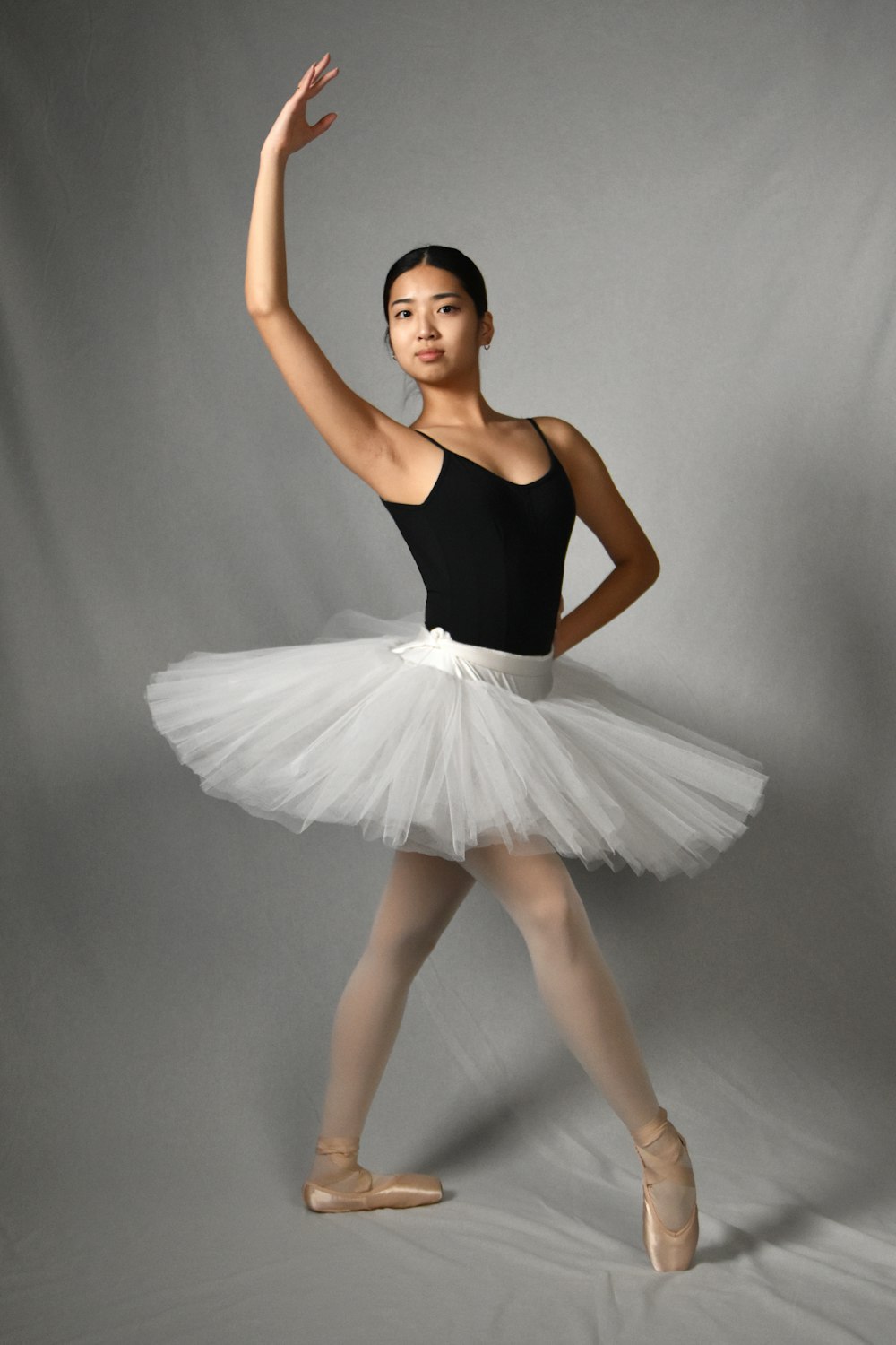 a woman in a black top and white tutu